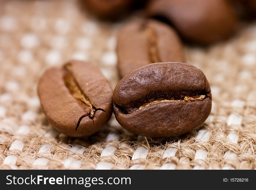 Brown coffee grains on a sacking macro