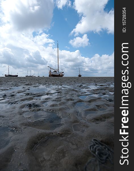 A boat stranded on the sands of the Waddenzee by the outgoing tide. A boat stranded on the sands of the Waddenzee by the outgoing tide.