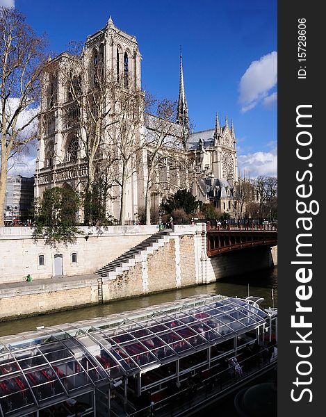 Notre Dame on the Seine River with touring glass boat. Notre Dame on the Seine River with touring glass boat