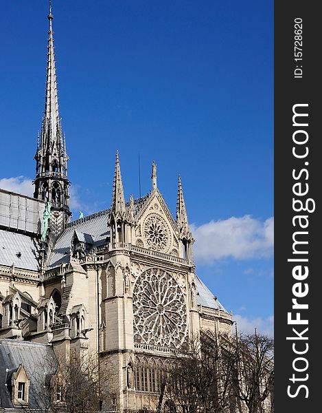 Architecture of Notre Dame Cathedral in Paris, France with bright blue sky. Architecture of Notre Dame Cathedral in Paris, France with bright blue sky