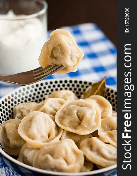 Russian pelmeni (meat dumplings) with sour cream