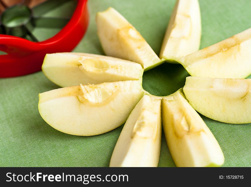 Cut apple in shape of flower and a red corer