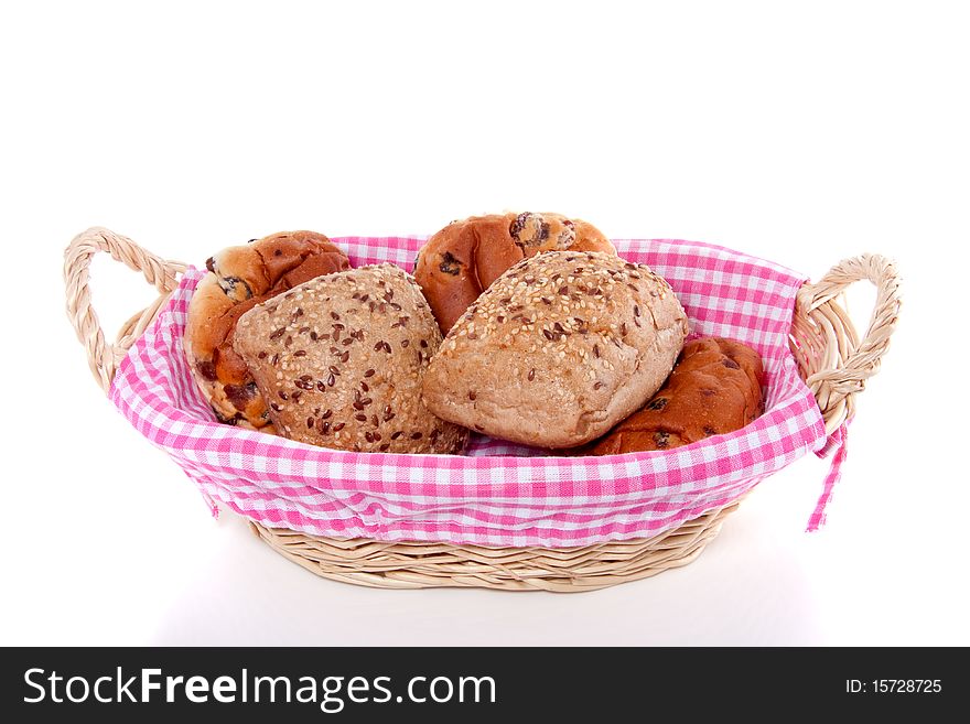 Healthy rolls in a pink checkered wicker basket isolated over white. Healthy rolls in a pink checkered wicker basket isolated over white