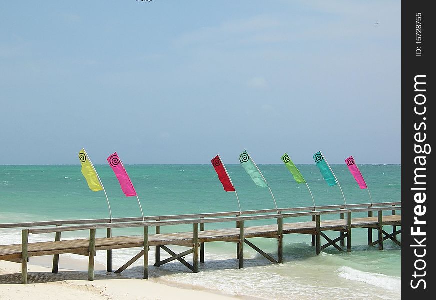 Flags flying on a deserted pier in the Bahamas. Flags flying on a deserted pier in the Bahamas