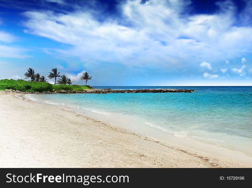 Perfect tropical beach with white sand, clear turquoise water, and dramatic blue sky. Perfect tropical beach with white sand, clear turquoise water, and dramatic blue sky