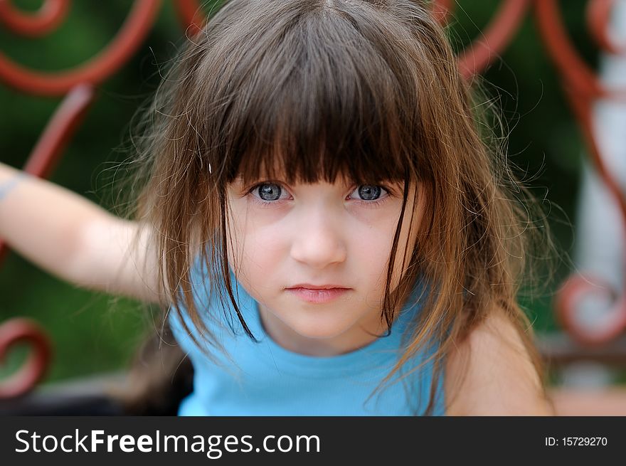 Nice toddler girl with beauty blue eyes looking into the camera