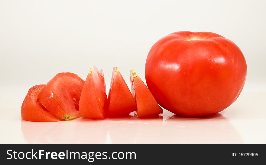 Tomato and pieces on a white background