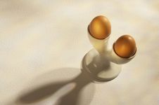 Two Brown Eggs In Double White Egg Cup Stock Photos
