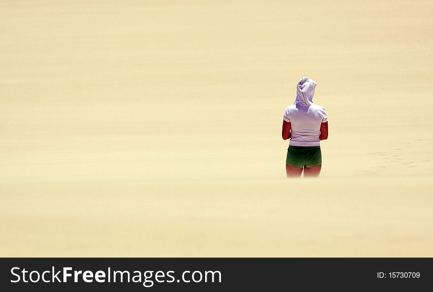 Girl looking over the endless sea of sand. Girl looking over the endless sea of sand