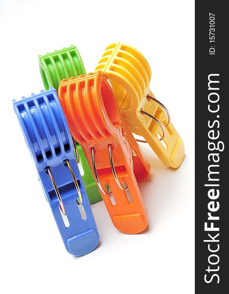 Four colorful clothes pegs on white background