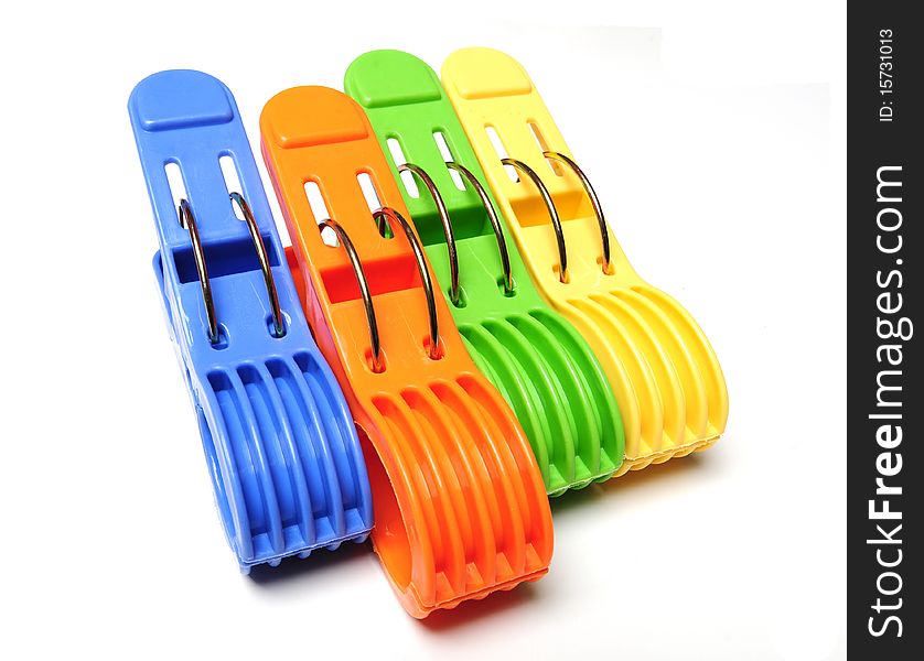Four colorful clothes pegs in a row on white background