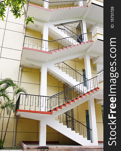 Closeup of concrete stairway with brick stairs and stucco walls