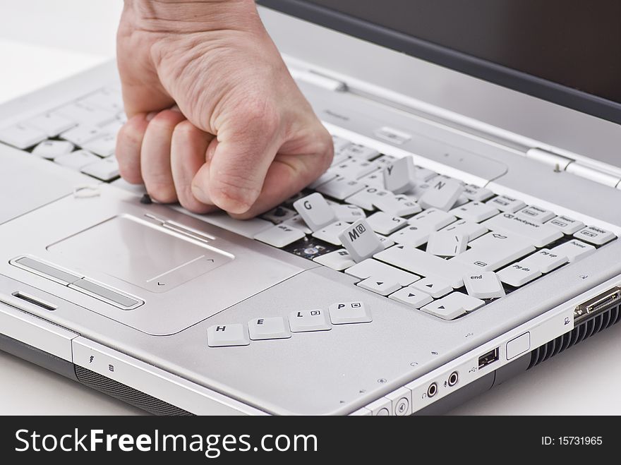 By hand damaged laptop on white background with help word. By hand damaged laptop on white background with help word