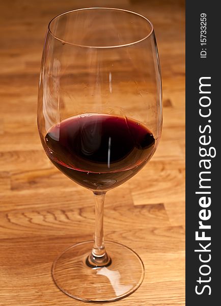 Glass of red wine on a wood table