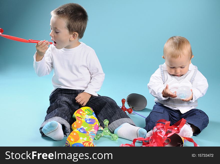 Beautiful caucasian kids playing with toys in studio. Beautiful caucasian kids playing with toys in studio