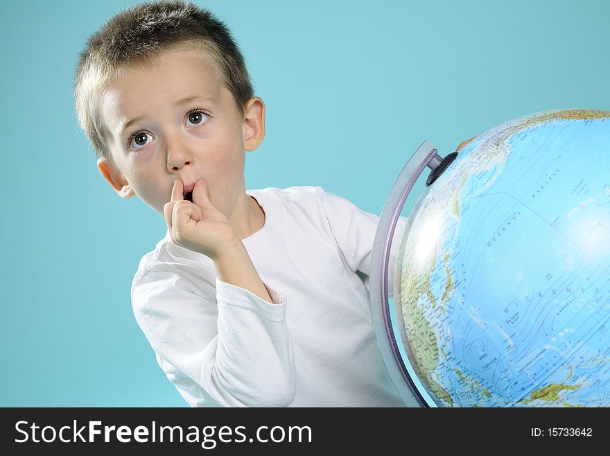 One child evaluating destinations on globe
