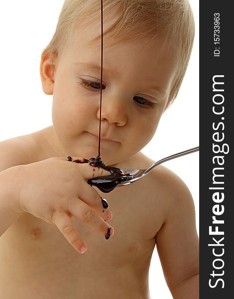Baby playing with chocolate on white. Baby playing with chocolate on white