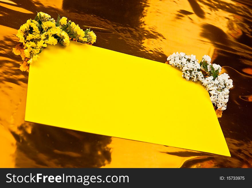Yellow paper with flowers on yellow background. Yellow paper with flowers on yellow background