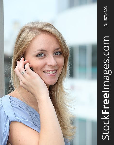 Closeup of young blond woman with mobile phone. Closeup of young blond woman with mobile phone
