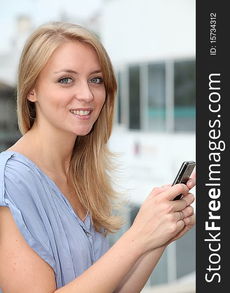 Closeup of young blond woman with mobile phone. Closeup of young blond woman with mobile phone