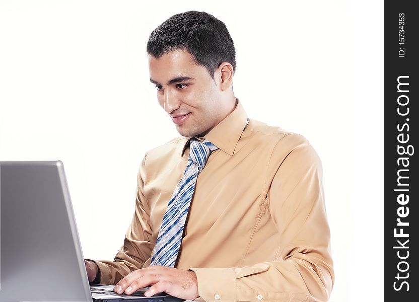 Young happy businessman using laptop, isolated on white