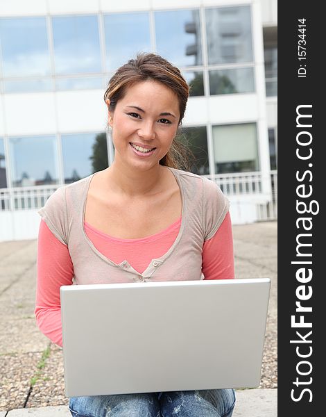 Student in college campus with laptop computer. Student in college campus with laptop computer