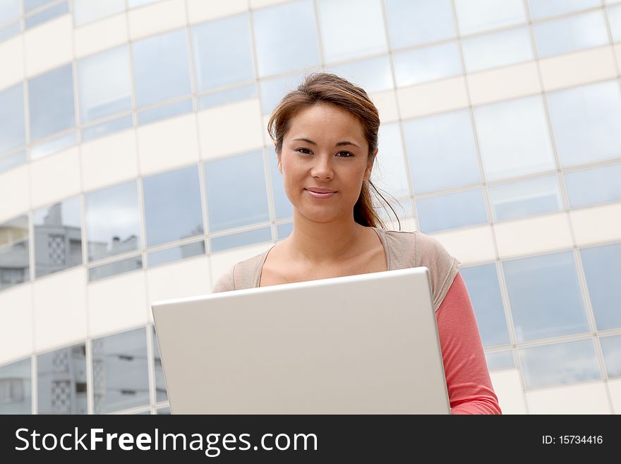 Student in college campus with laptop computer. Student in college campus with laptop computer