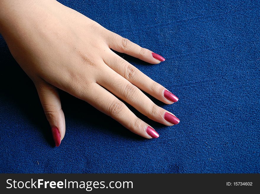 Woman hand on blue background.