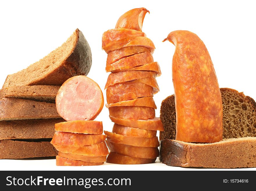Breakfast close-up. Slices of sausage and bread isolated on white background. Breakfast close-up. Slices of sausage and bread isolated on white background