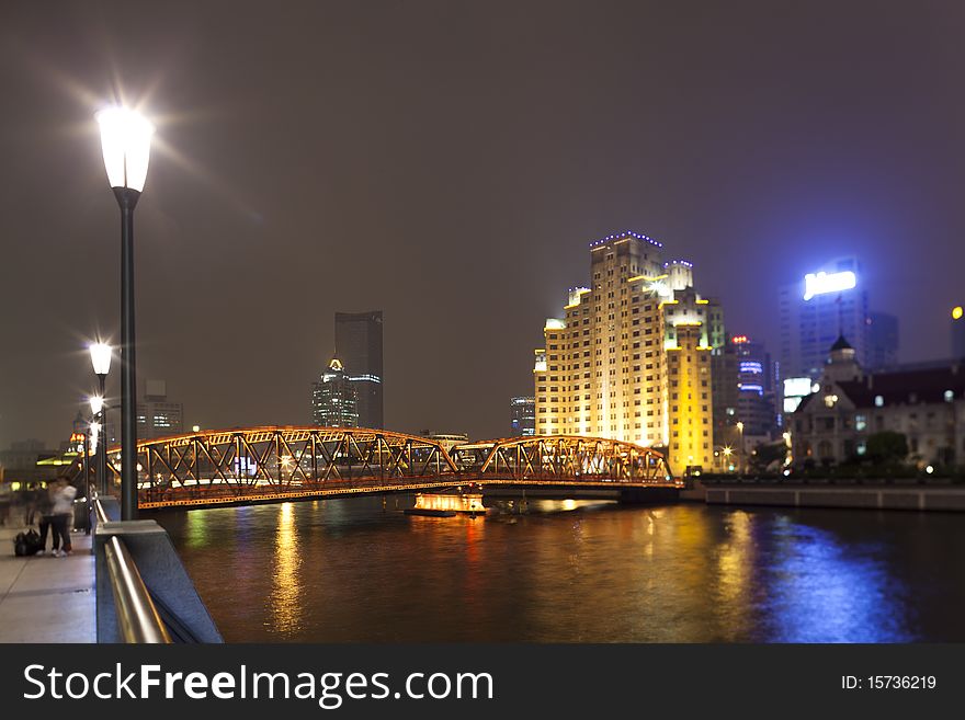 Shanghai/China: Old bridge at nighttime illuminated by street lights at the famous The Bund in Shanghai. Shanghai/China: Old bridge at nighttime illuminated by street lights at the famous The Bund in Shanghai.