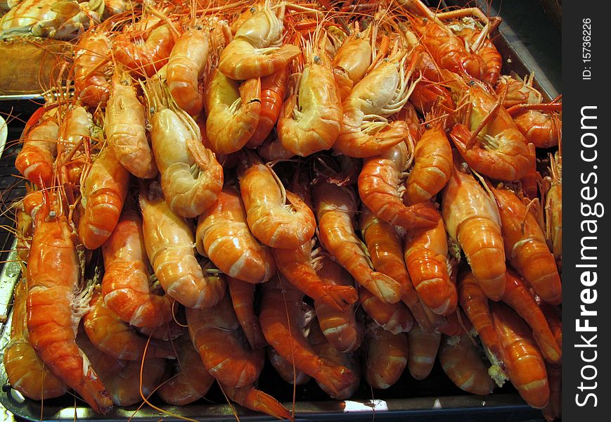 A big pile of cooked shrimps on a tray. A big pile of cooked shrimps on a tray