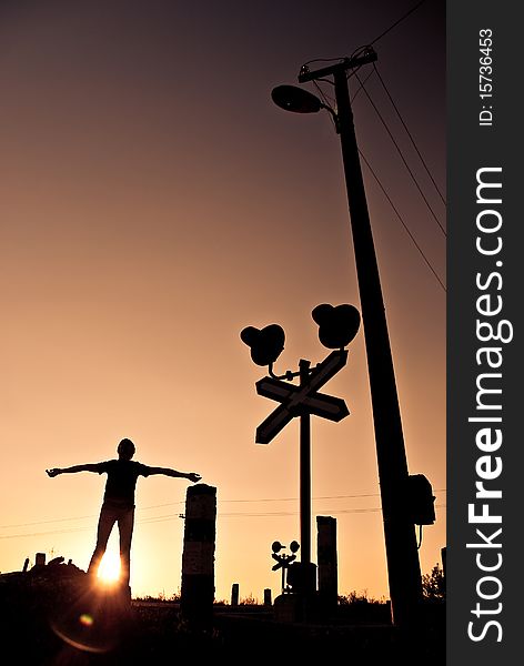 Young man spreading an arms at summer sunset crossroads. Young man spreading an arms at summer sunset crossroads