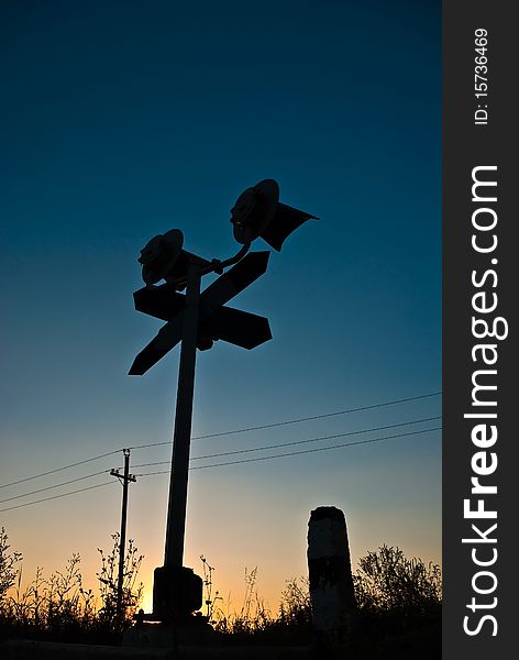 Silhouette of a railway stop sign at summer sunset. Silhouette of a railway stop sign at summer sunset