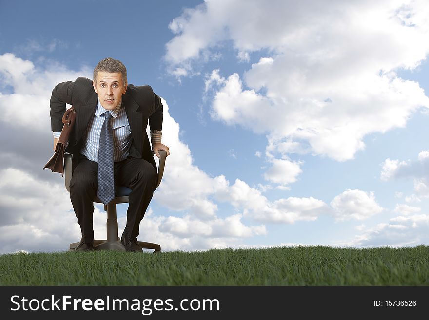 The businessman goes in an armchair across the field
