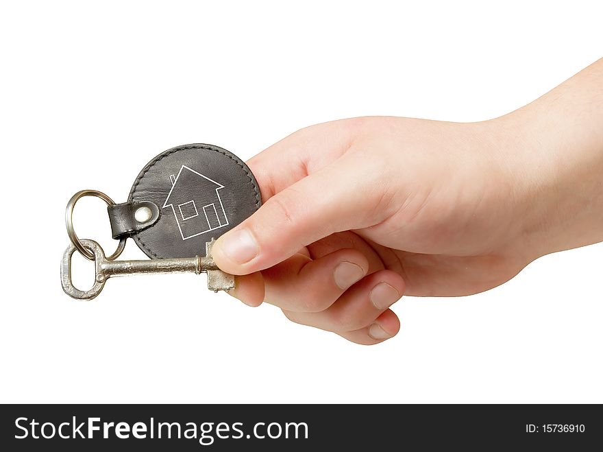 Retro key trinket in human hand isolated with clipping path. Retro key trinket in human hand isolated with clipping path