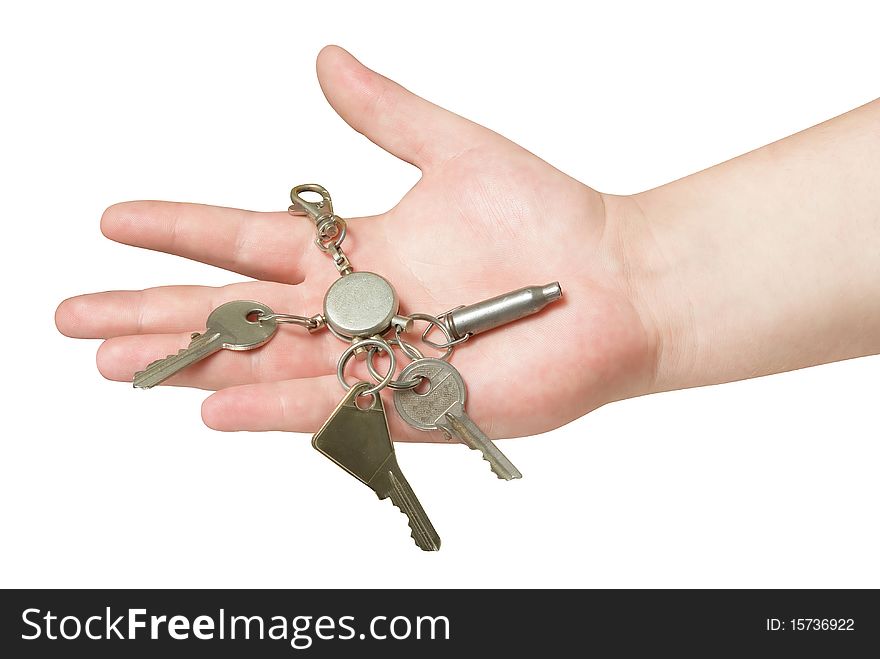 Key trinket in human hand isolated with clipping path