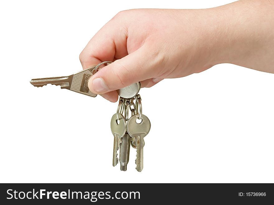 Key trinket in human hand isolated with clipping path