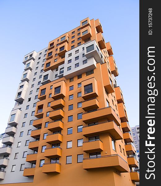 A tall modern multistory apartment block. A tall modern multistory apartment block