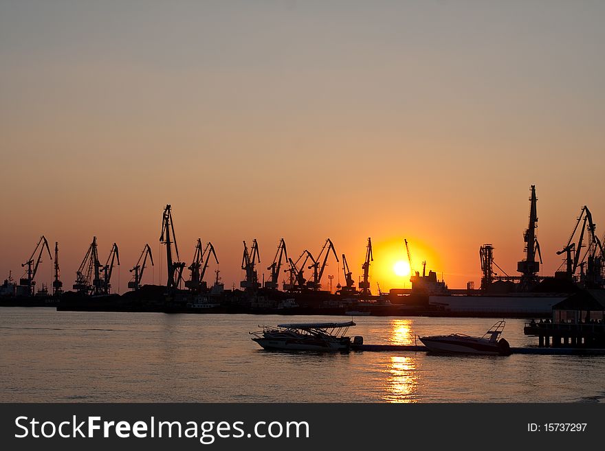 Seaport with the tower cranes at sunset