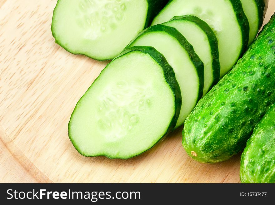 Sliced fresh cucumber on the chopping-board. Sliced fresh cucumber on the chopping-board