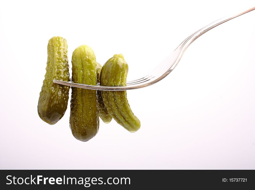 Marinated cucumber on fork (close up, clipping path)