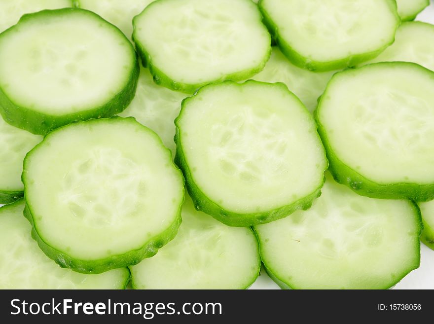 Sliced ripe yummy cucumber on white background (close up). Sliced ripe yummy cucumber on white background (close up)