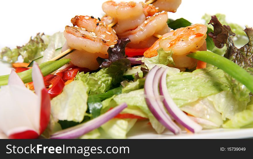 Shrimps on a spit with fresh mixed salad. Shrimps on a spit with fresh mixed salad