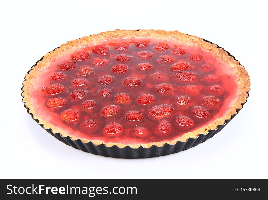 Strawberry Tart in a tart pan on a white background