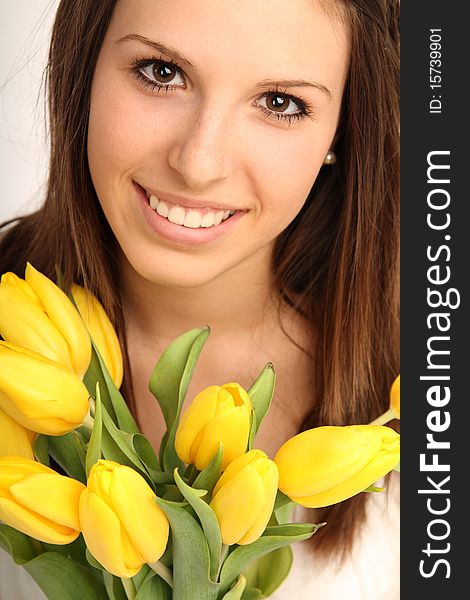 Young brunette woman with yellow flowers. Young brunette woman with yellow flowers