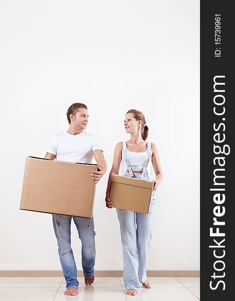 Attractive couple moves cardboard boxes in new home