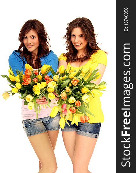 Two beautiful girls holding a bouquet. Two beautiful girls holding a bouquet
