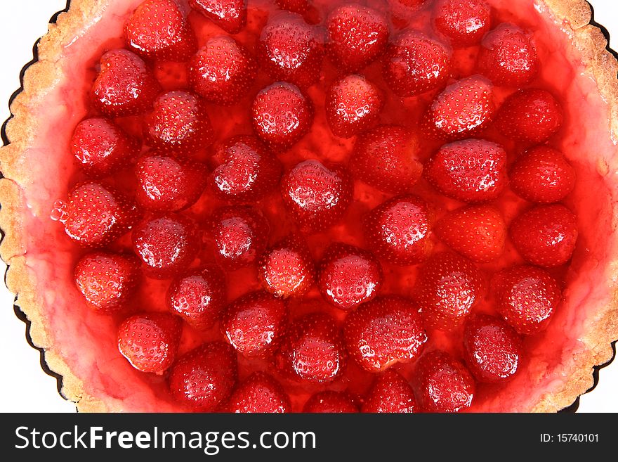 Strawberry Tart in a tart pan in close up on a white background