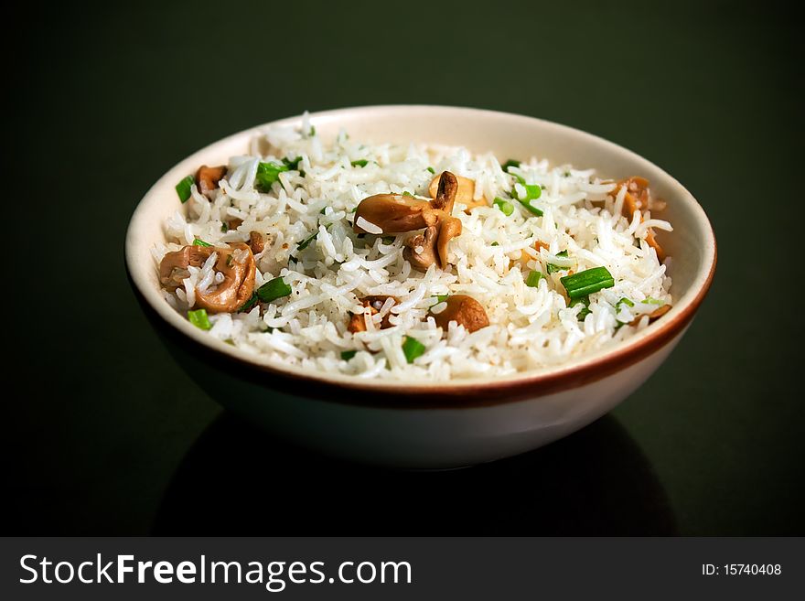 Risotto with mushrooms for meal over black background made from rice. Risotto with mushrooms for meal over black background made from rice