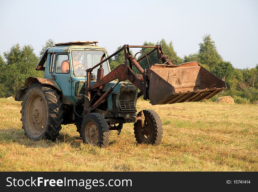 Russian tractor with a bucket on the farm. Russian tractor with a bucket on the farm.